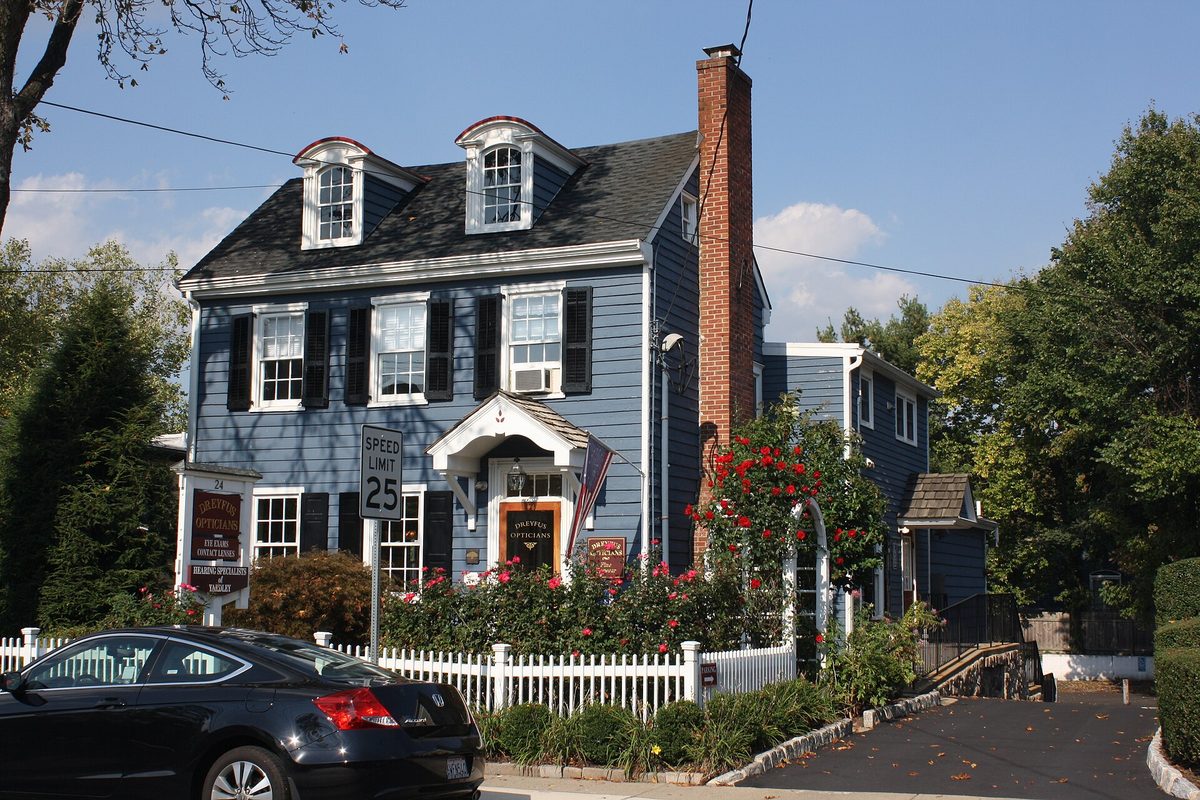 A clapboard colonial with the shutters and the picket fence doing exactly what you expect, on Main Street in Yardley.