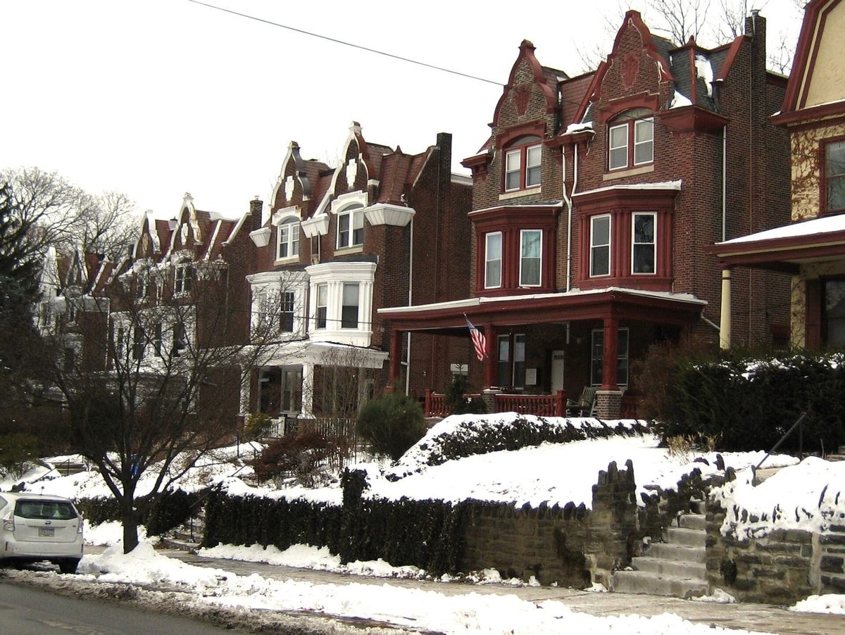 Twin houses in West Mount Airy after a snow. Shared walls, deep porches and a build date the appraiser will want to discuss.